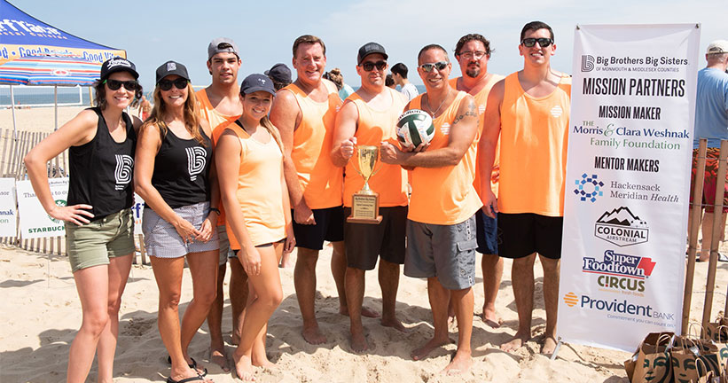 Members of Provident Bank’s Sand Sharks volleyball team