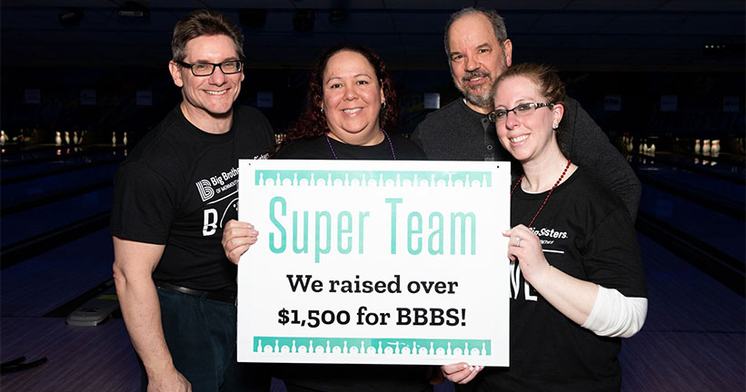 Bowling Team winners holding sign 