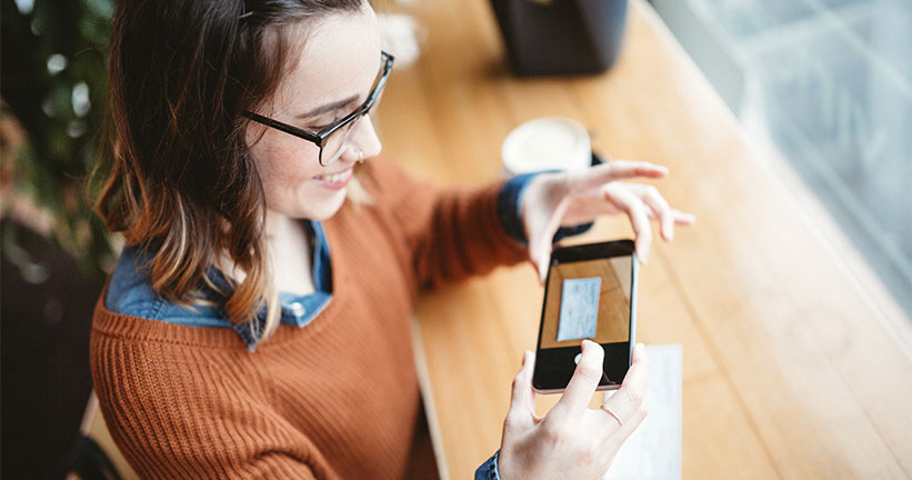 Woman doing a remote check deposit 