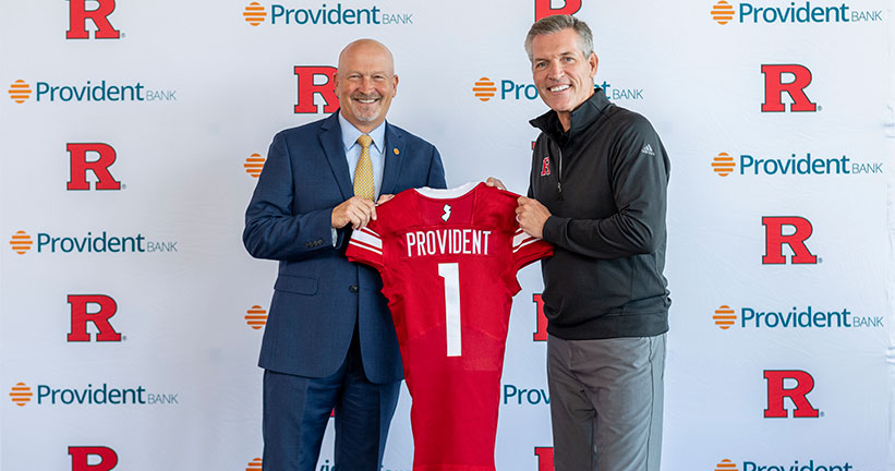 Chris Martin and Pat Hobbs holding Rutgers jersey 